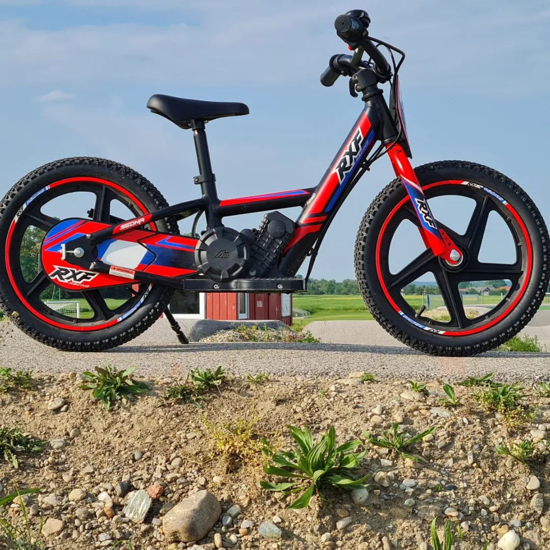 Dječji električni bicikl Apollo Sedna 16 RXF crno-crvene boje bočni pogled na otvorenom prostoru