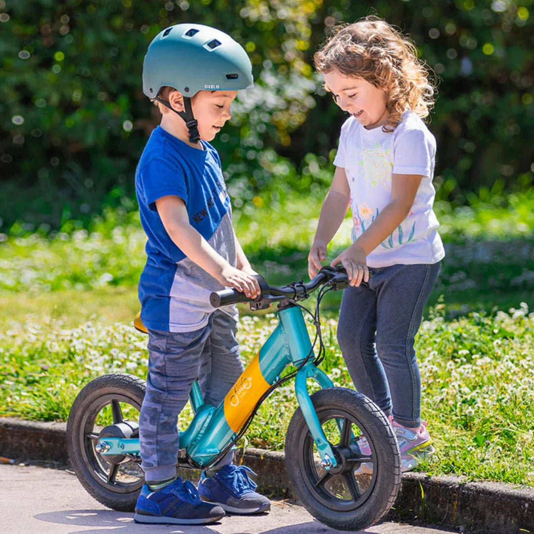 Djeca se igraju s plavo-žutom električnom guralicom Fiido Kidz na otvorenom