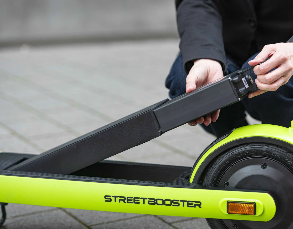 Zamjenjiva crna baterija za električni romobil Streetbooster Sirius u rukama korisnika