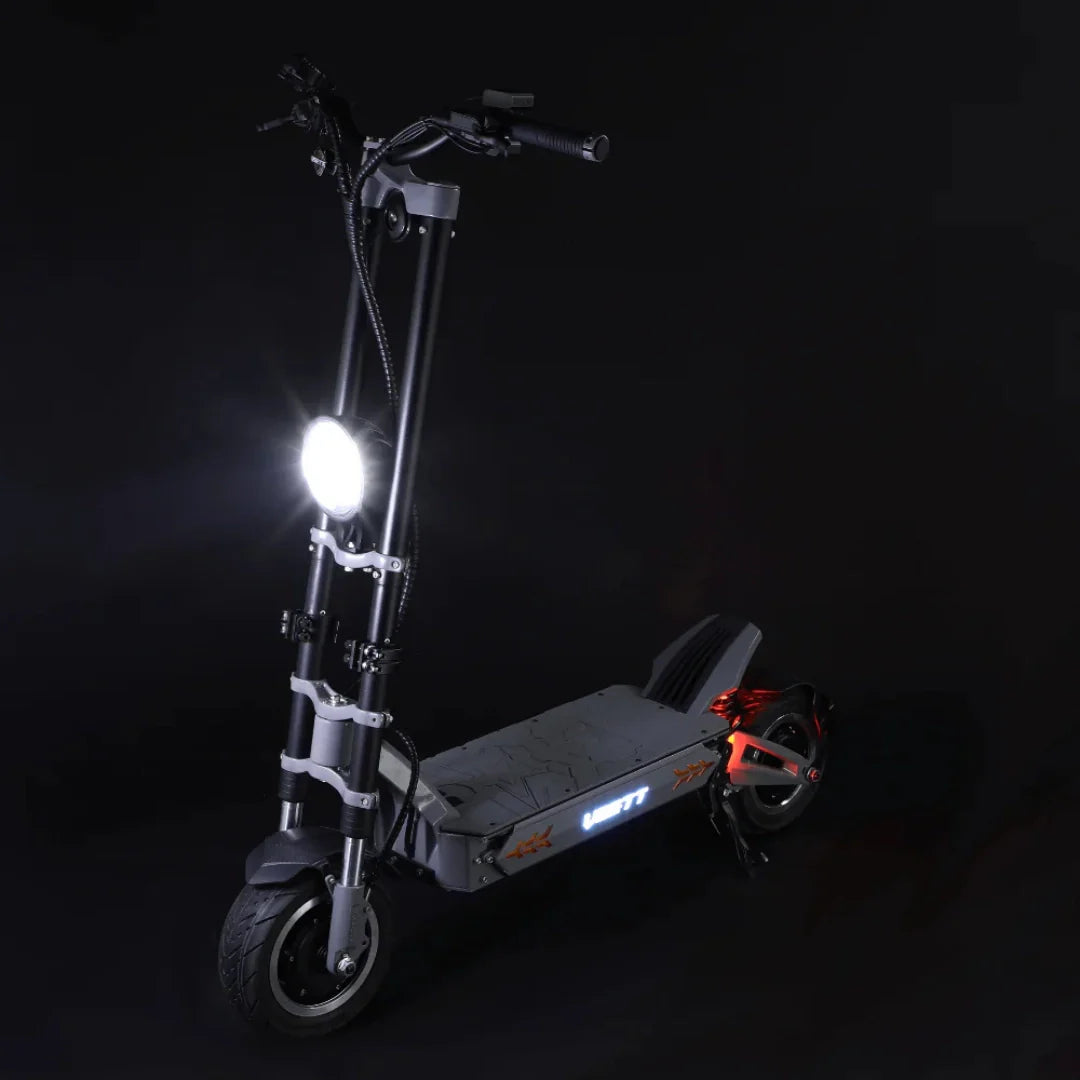 Električni romobil Vsett 11+ s upaljenim prednjim i bočnim svjetlima na crnoj pozadini