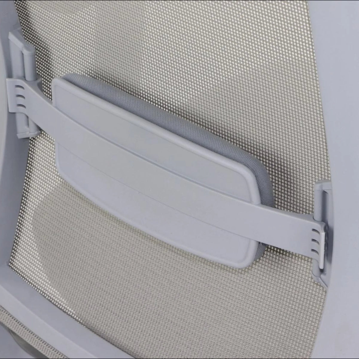 Proizvod je ergonomska uredska stolica, točnije model Cutler. Slika prikazuje krupni plan naslona za leđa stolice, koji ima mrežasti dizajn i podesivi jastučić za lumbalnu potporu pričvršćen trakom. Ovaj dizajn ima za cilj povećati udobnost i pružiti potporu korisniku tijekom dugih razdoblja sjedenja.