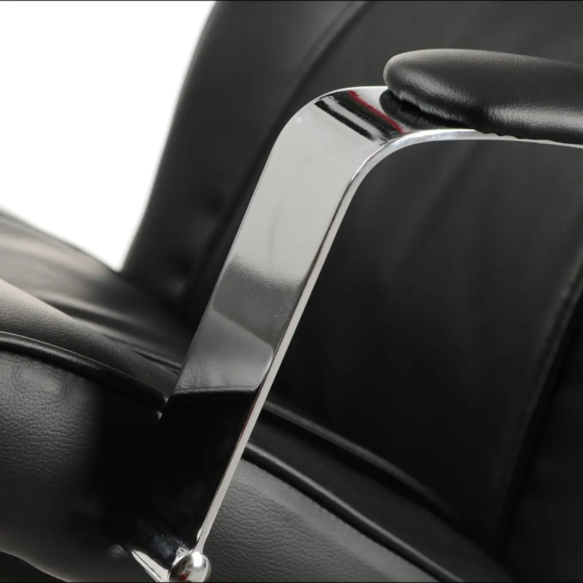 Slika prikazuje ergonomsku uredsku stolicu, model ZN-9152. Odlikuje se elegantnim dizajnom s kromiranim naslonom za ruke i crnim kožnim presvlakama, naglašavajući udobnost i modernu estetiku. Fokus na naslon za ruke ističe kvalitetnu izradu stolice.